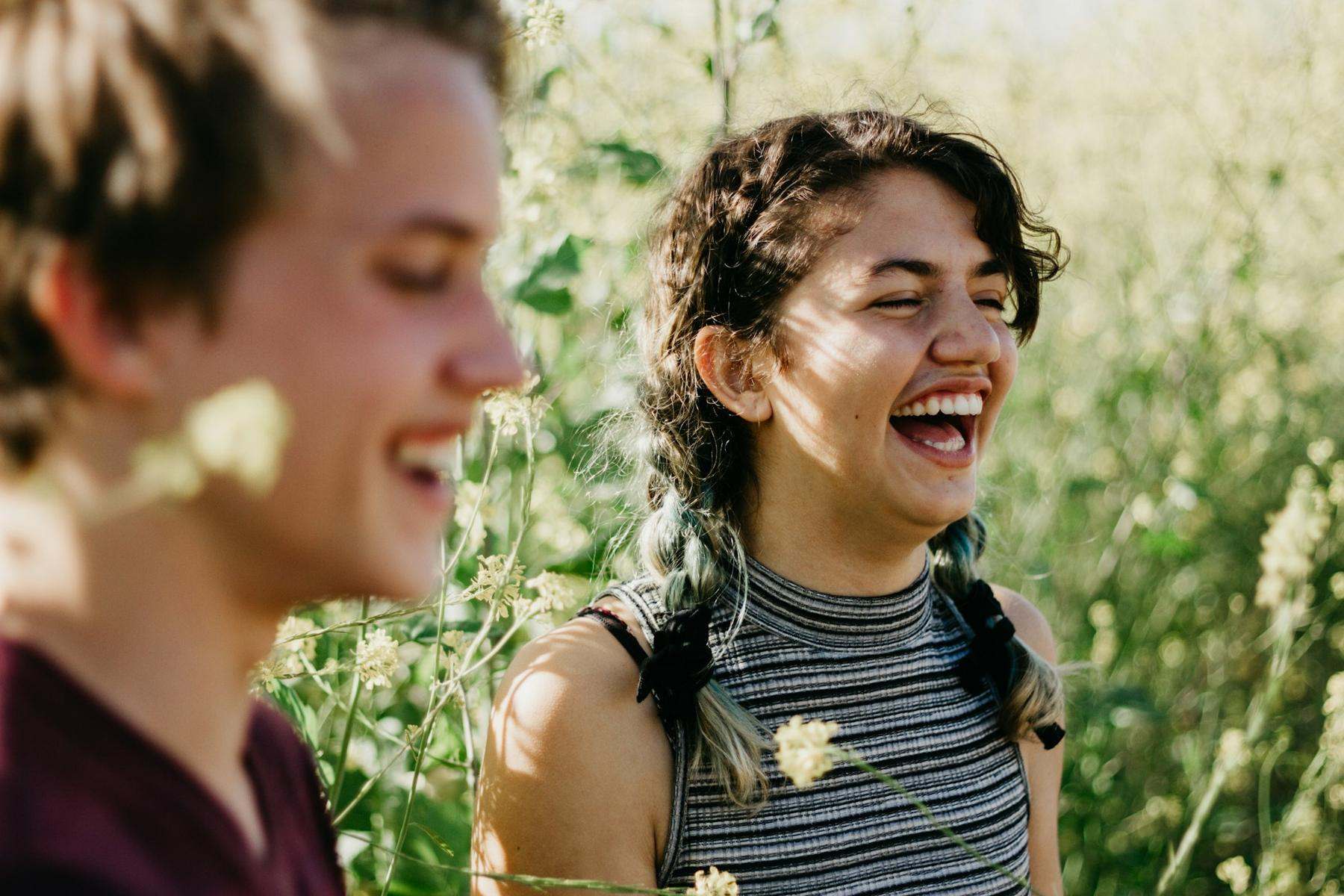 Two friends laughing outdoors