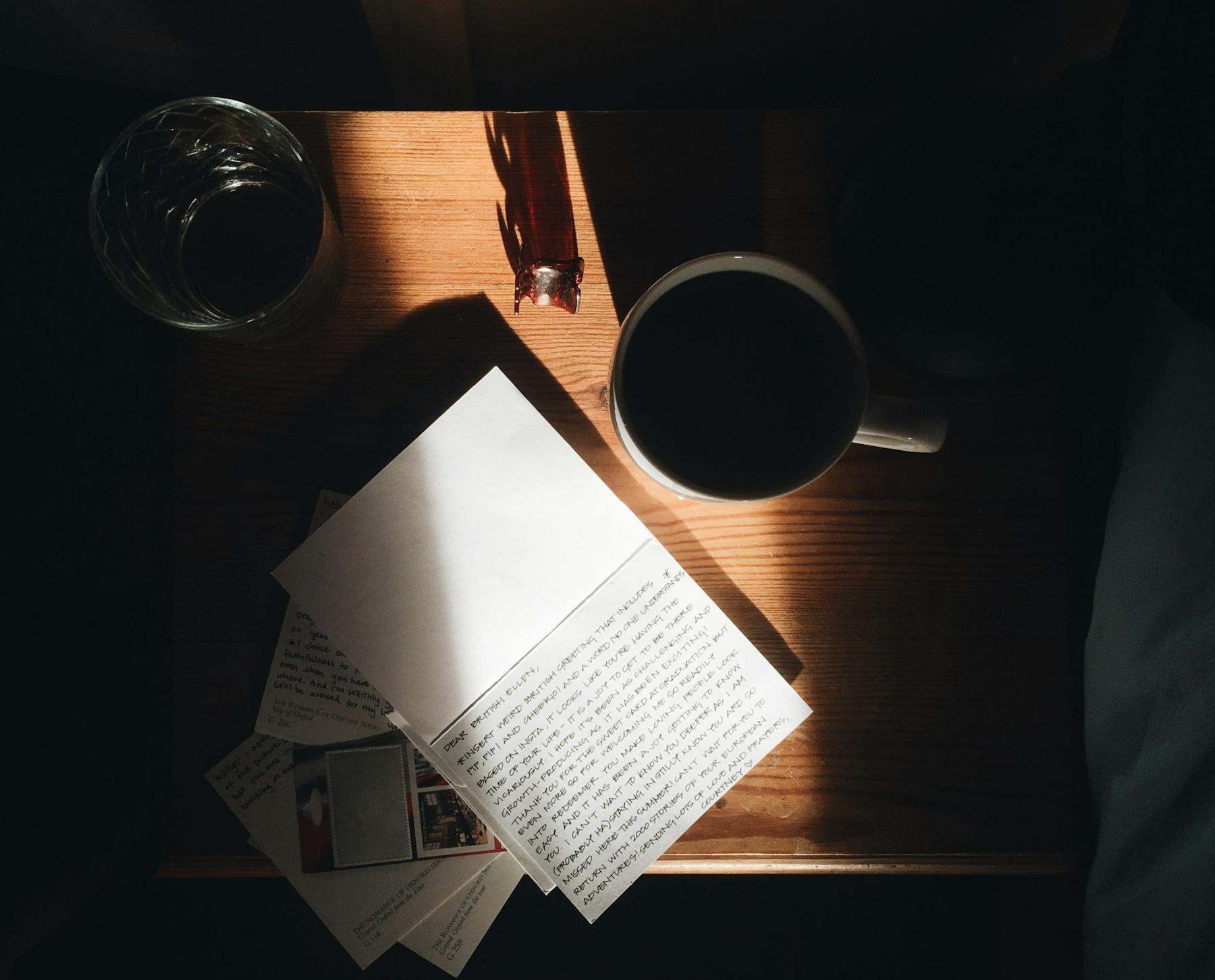 A desk with a notebook and a mug