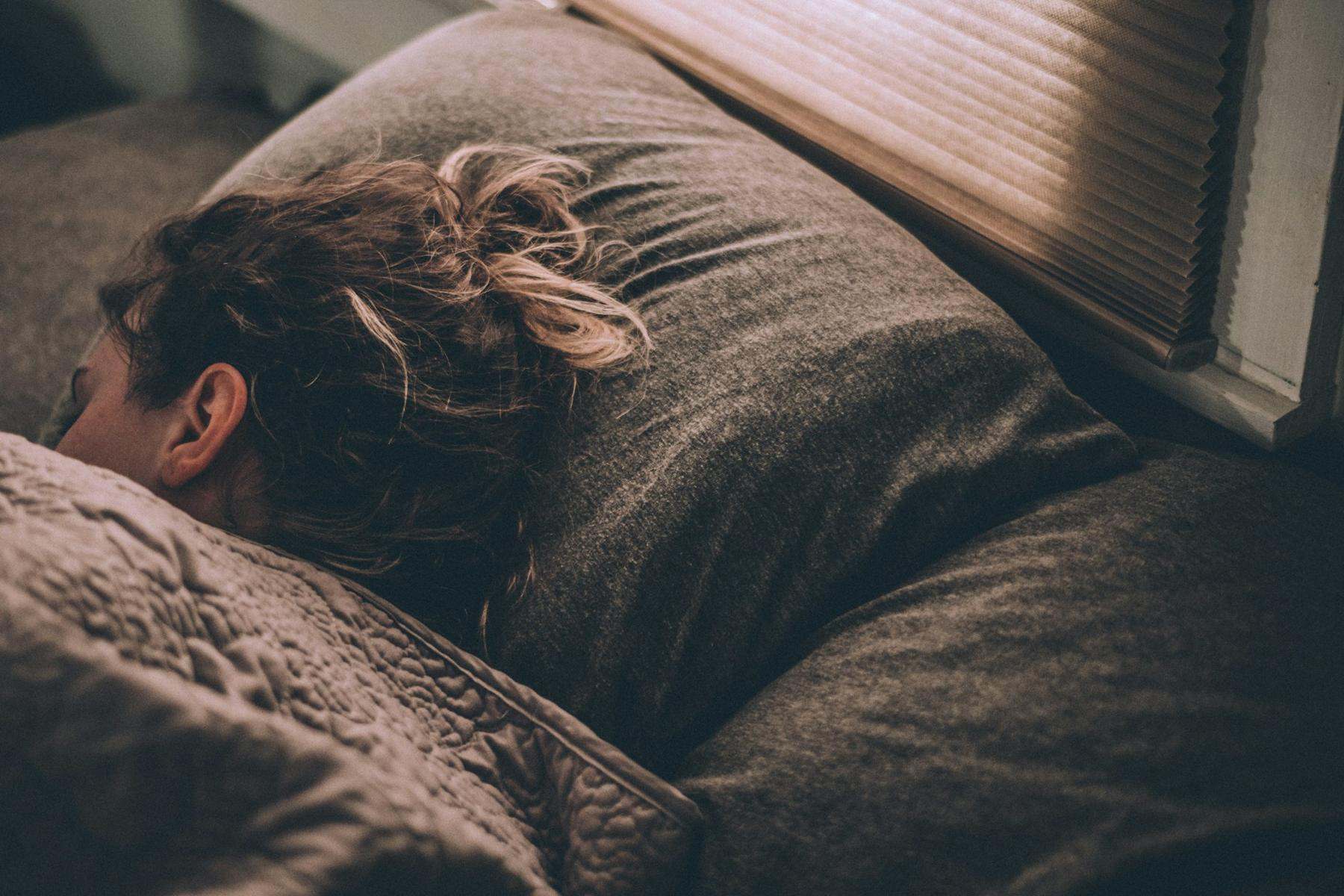 Someone asleep, face in the pillow